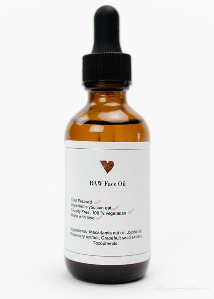 RAW Face Oil front image: Crystal bottle with delicate face oil. Beige label and wooden heart. Organic skin care. Affordable skin care. Cold-pressed. Healthy skin. Ethically made.